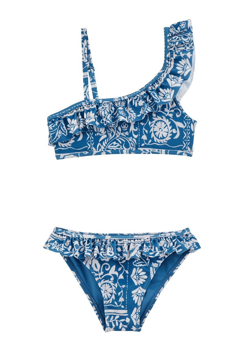 Diviņš biksītes komplekts zilos toņos ar baltu ziedu rakstu. Augšējā daļa ar vienu pleca siksnu un frillēm; apakšējā daļa ietver atbilstošas frilles.