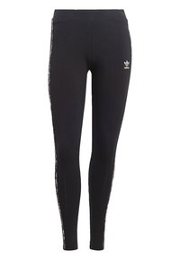 Svarta leggings i ett mjukt, elastiskt tyg. Har en vit logotyp på höften och kontrasterande randiga detaljer längs sidorna.