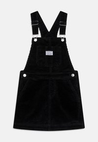 Černé kordové šaty na výlety s nastavitelnými ramínky, dvěma předními kapsami a detailním štítkem v oblasti hrudi.