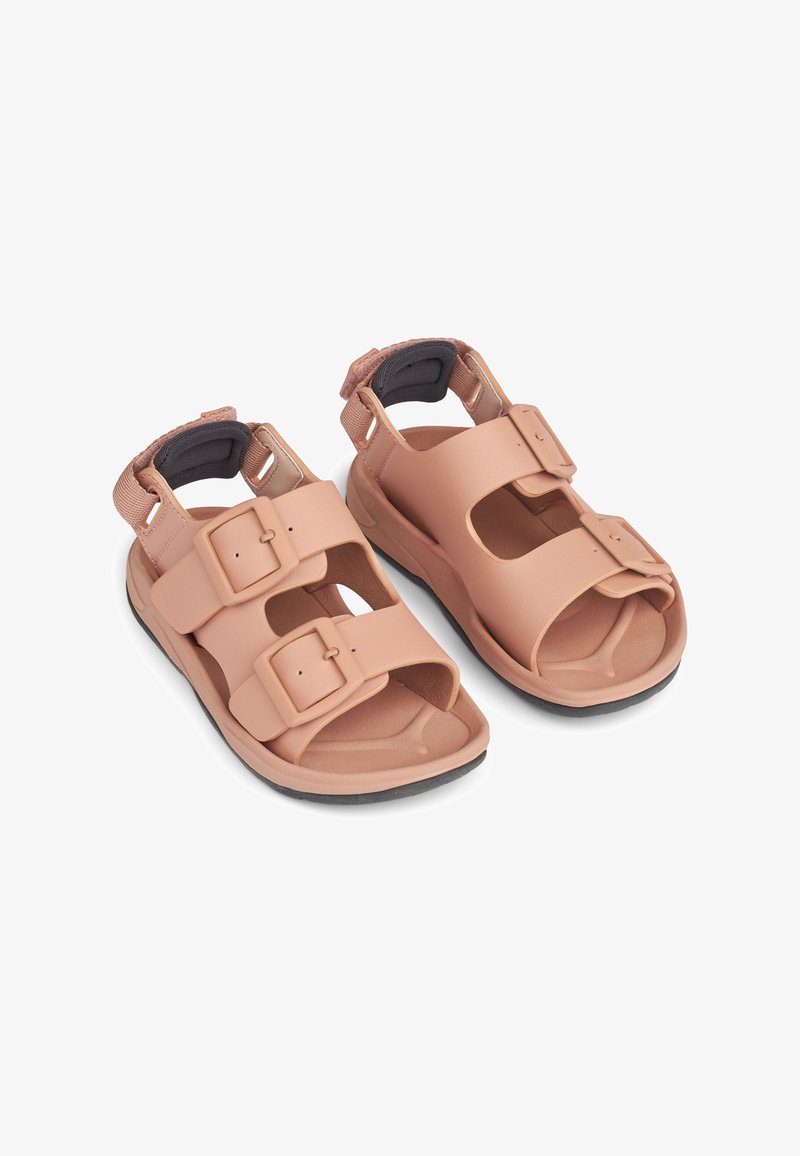 Light pink sandals made of synthetic material, featuring two adjustable buckle straps, open toe design, and a cushioned sole with a black outsole.