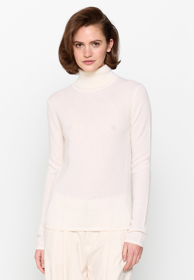 Maglione a collo alto di un crema chiaro realizzato in morbido tessuto a maglia testurizzato. Presenta maniche lunghe e un design a gradiente sottile all'orlo.
