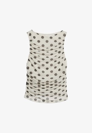 Débardeur crème avec de grands pois gris. Présente une texture froncée sur les côtés, des bretelles larges et un ourlet arrondi.