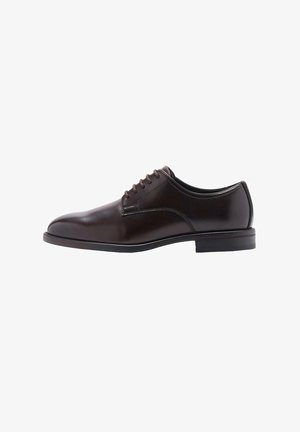 Scarpa da uomo in cuoio marrone con finitura liscia, punta rotonda e sei fori per i lacci. Presenta un tacco basso e una cucitura discreta lungo i lati.