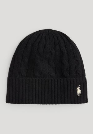 Black knit beanie with cable pattern and ribbed brim, featuring a small white polo logo on the side. Soft texture, classic design.