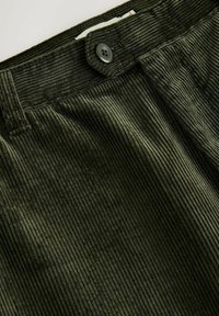 Dark green corduroy pants with vertical ribbed texture and a single black button closure at the waistband.