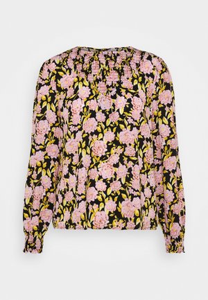 Long-sleeve floral blouse with pink flowers and green leaves on a black background and smocked neckline and cuffs.