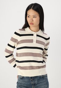 Knitted striped sweater in cream, burgundy, and black. Features a collar, button placket, and ribbed hem. Textured fabric with varying widths.
