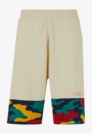 Béžové sportovní šortky s žebrovaným pasem, na spodním lemu s barevným maskáčovým vzorem v modré, zelené, červené a žluté barvě. Detail s logem.