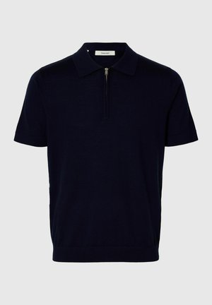 Polo de manga corta azul marino con cremallera en la parte frontal y cuello clásico, confeccionado en tela ligera.