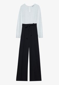 Jumpsuit with a light blue, patterned top featuring long sleeves and a deep V-neck, and black wide-leg trousers with a belted waist.
