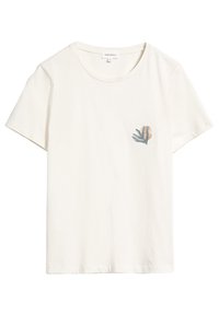 Camiseta de algodón color crema de manga corta con un pequeño gráfico de una mano y un sol en el lado izquierdo del pecho. Escote redondo liso y corte relajado.