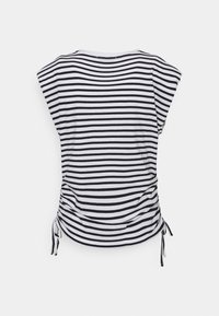 Haut rayé noir et blanc à manches courtes, côtés froncés et liens ajustables à l'ourlet pour une silhouette ajustée.