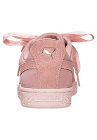Puma-Sneaker aus hellrosa Wildleder mit Satinschnürsenkeln. Verfügt über strukturierte Seitenpaneele und eine gummierte Sohle mit geprägtem Logo.
