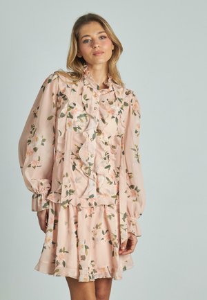 Abito floreale rosa realizzato in tessuto leggero, con ruches, maniche con polsini e una gonna a strati con chiusura a bottone.