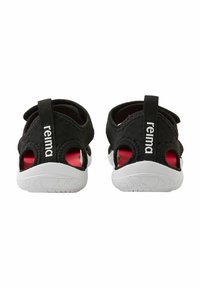Black water shoes with white soles, open-back design, textured fabric, and red accents, featuring a logo on the heel strap.