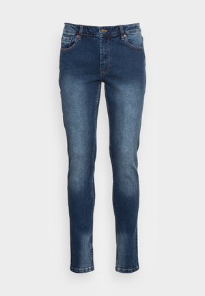 Denimjeans i mørkeblå, slim-fit design med kontrasterende syninger. Har lynlås i gylpen, fem lommer og let falming på lårene.