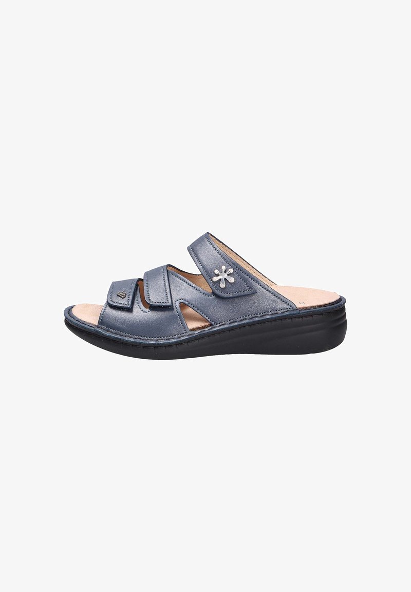 Dark blue slide sandal featuring three crossed straps, small decorative flower accent, and a cushioned insole with a black sole.