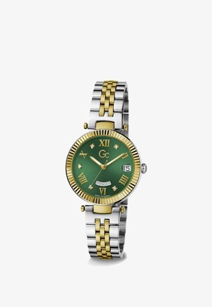 Reloj con tono dorado y plateado, de esfera redonda verde, números romanos, acentos de diamantes y pulsera de acero inoxidable y tono dorado.