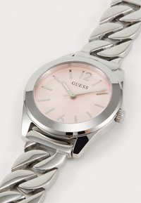 Silver stainless steel watch with a polished case, pink dial, and large numerals. Chunky metallic bracelet with interlocking links.