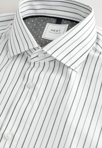 White dress shirt with gray vertical stripes, single-button closure, and a contrasting gray patterned collar lining. Brand label visible.