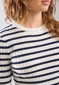 Striped top with navy and white colors, ribbed texture, round neckline, and long sleeves. Features narrow horizontal stripes.