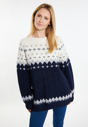 Strickpullover mit einer Farbgebung in Creme, Marineblau und Grau, verziert mit geometrischen Mustern. Grobe Kabelstrick-Textur und weite Ärmel.
