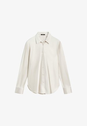 Chemise blanche à manches longues en tissu lisse, dotée d'un col classique, d'une fermeture à boutons à l'avant et d'un ourlet arrondi. Design simple sans motifs.