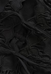Black fabric with intricately embroidered wavy patterns. Features ties and a gathered area, creating texture and visual interest.