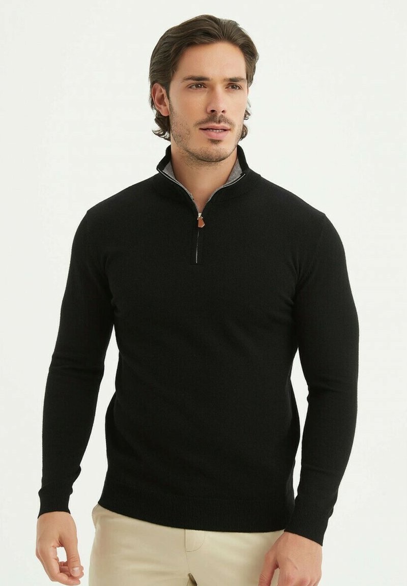 Sweat à zip noir avec un col haut et un intérieur gris contrasté. Fabriqué en tissu tricoté texturé, avec des manches longues ajustées.