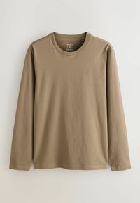 Long-sleeve, crew-neck t-shirt in a light brown color, made of soft fabric with a subtle logo on the left chest and stitched hem details.