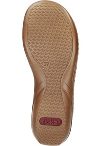Brown rubber outsole featuring a wavy tread pattern, embossed logo, and size label. Contoured edges for flexibility and movement.