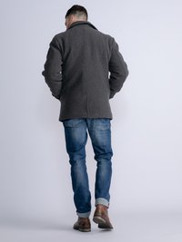 Dark gray wool coat with a structured collar, paired with blue denim jeans and brown leather boots, viewed from the back.