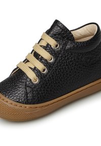 Černé kožené tenisky s texturovaným povrchem, béžovými šňůrkami a kovovými oky. Mají hnědou gumovou podrážku a zaoblený tvar špičky.