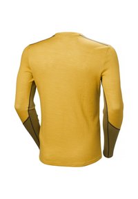 Halenka s dlouhými rukávy v zlaté žluté barvě s texturovanou tkaninou. Obsahuje hnědé akcenty na rukávech, kontrastní stehy a kulatý dekolt.