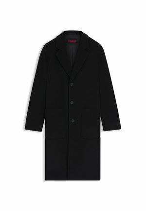 Schwarzer Wollmantel mit Reverskragen, drei vorderen Knöpfen, zwei großen Taschen und einer leichten A-Linie-Silhouette.