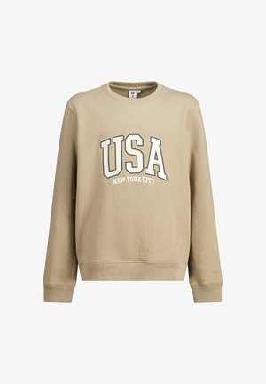 Sweat-shirt beige à manches longues avec poignets et ourlet côtelés, avec de grandes lettres blanches USA et un texte plus petit "New York City" en dessous.