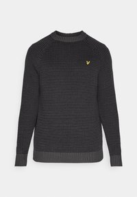 Dark grey knitted sweater featuring a ribbed crew neckline and cuffs, with a small yellow logo on the left chest. Textured surface detail.