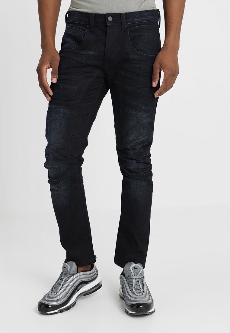 Mörk tvättade jeans med slim fit, som har fem fickor, knap stängning och subtil blekning vid lår- och knäområdena.