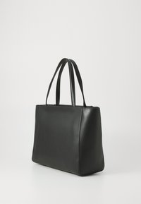 Black leather tote bag with a rectangular shape, smooth texture, and dual handles. Minimalist design, no visible hardware or accents.