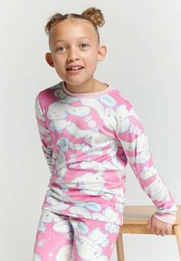Long-sleeve pink pajama set featuring white and blue bunny patterns with accent colors. Soft fabric and relaxed fit; ideal for comfort.
