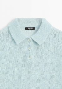 Light blue knitted polo sweater with a soft texture and three white buttons down the front collar area.