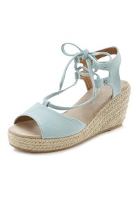 Svetlo modra kanvas rampantna sandal s odprto konico, prepletajočimi se vezi okoli gležnja in teksturiranim espradril jutom na peti. Insole, podoben semišu.