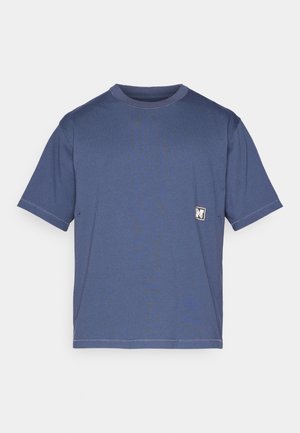 Navy blue t-shirt made of cotton, featuring a round neck, short sleeves, and a small logo patch on the front left side.