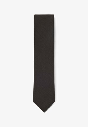 Sort slank slips med et subtilt tekstureret mønster, lagt fladt på en hvid baggrund.