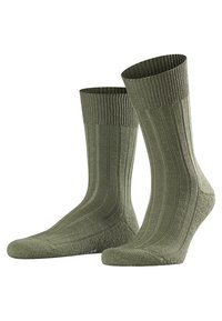 Calcetines de algodón verde oliva con textura acanalada y plantillas acolchadas, de longitud media (hasta la pantorrilla) y con talón y puntera reforzados.