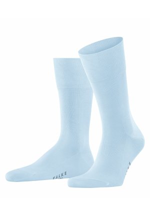 Himmelblaue Baumwollsocken mit glatter Textur, knielang und mit geripptem Bund. Mit dezentem Branding an der Sohle.