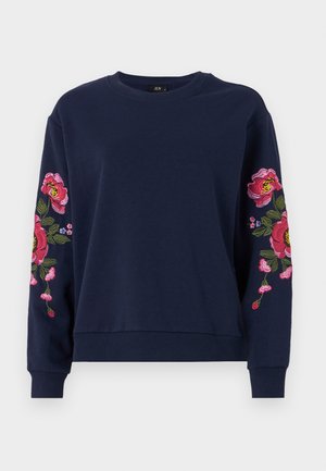 Sudadera azul marino con vibrante bordado floral en ambas mangas. Confeccionada en una tela suave con puños y dobladillo de canalé.
