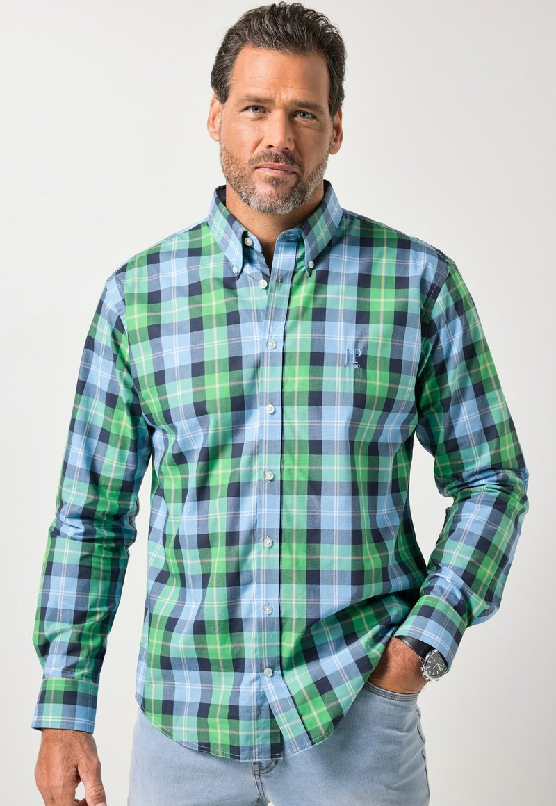 Grün-blau kariertes Hemd mit Knöpfen und Kragen, mit unterschiedlichen Quadratmustern und einem kleinen gestickten Logo auf der Brust.