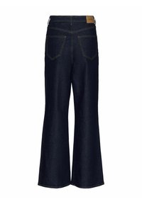 Mörkblå jeans i utsvängd modell med hög midja, med två bakfickor och kontrasterande gula sömmar. Läderetikett med varumärke på midjebandet.