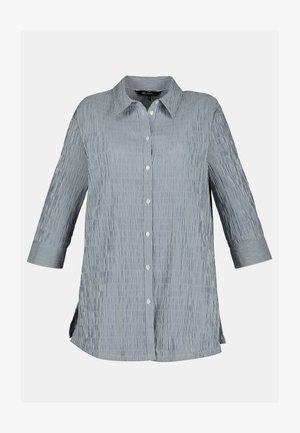 Leichtes, gestreiftes Hemd mit blauen und weißen vertikalen Streifen. Es hat einen spitz zulaufenden Kragen und Dreiviertelärmel.